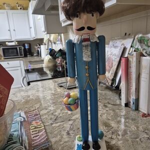 Blue Wooden Nutcracker Figurine with Colorful Egg Basket